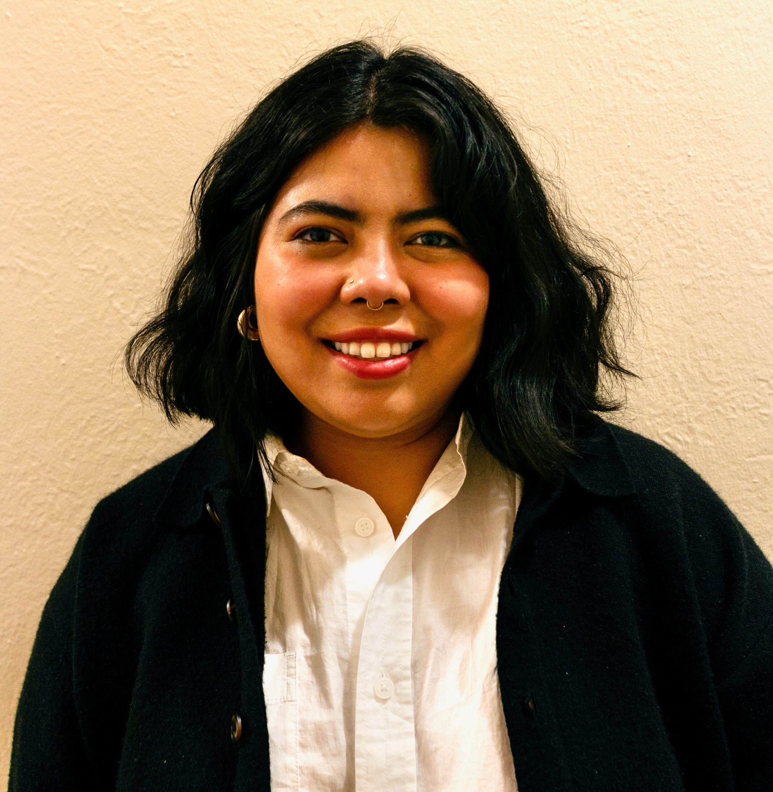 young Latina woman smiling wearing professional clothes