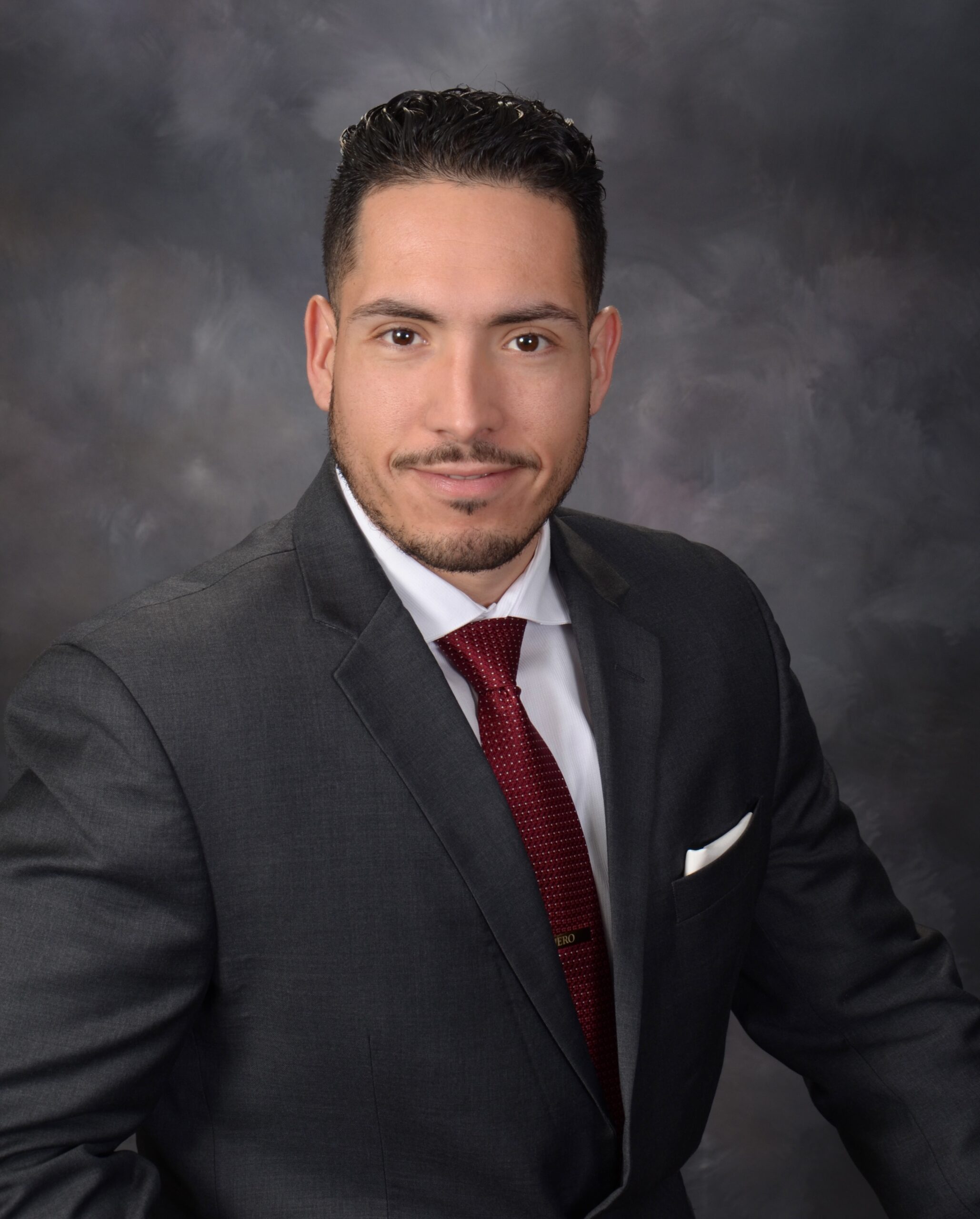 Latino law student wearing suit and tie